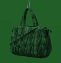 Green crocodile-embossed handbag with two top handles and a shoulder strap, hanging from a hook on a green background