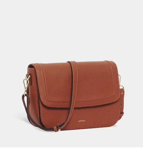 Rust-brown leather crossbody bag with a fold-over flap, gold clasps and an adjustable shoulder strap